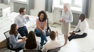 Business people employees group discussing work plan with coach mentor at corporate office meeting, multicultural workers sales team talking at company workshop training, top view overhead from above